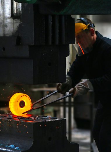 Guy Molding Metal in Metals Manufacturing Facility